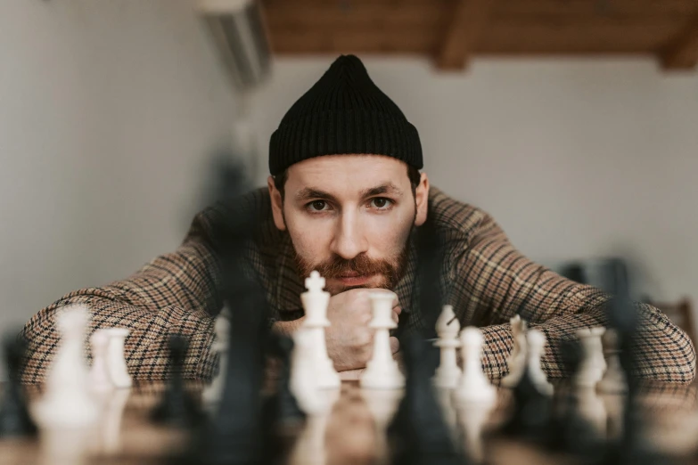 a man is looking through his chess board