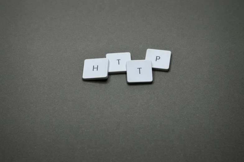 a computer keyboard sitting on top of a table, letters, on a gray background, gpt, server in the middle