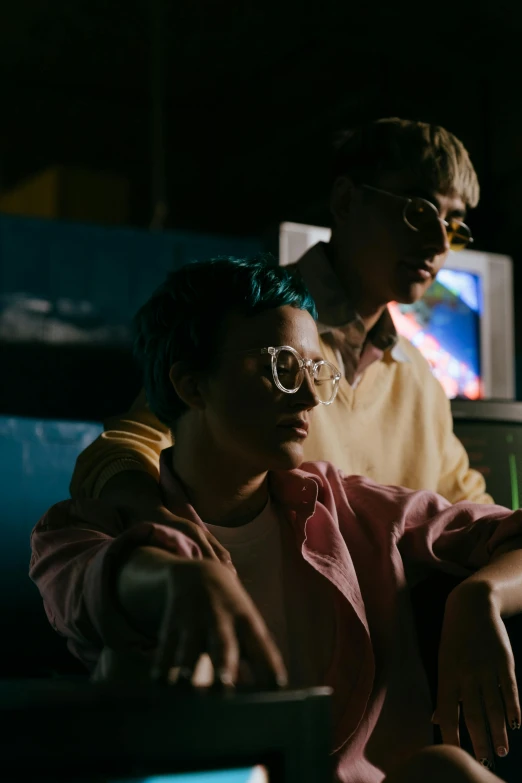 a man and a woman sitting in front of a laptop computer, an album cover, pexels, visual art, lesbians, television sunglasses, mid night, joel fletcher