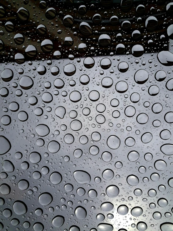 a close up of water droplets on a windshield, by Ryan Pancoast, portholes, grey, glass cover, close - up photograph