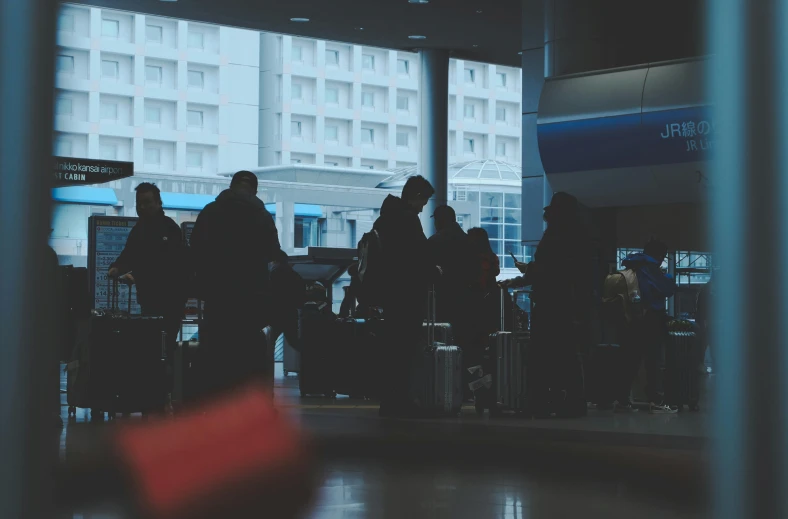 a group of people standing around with luggage