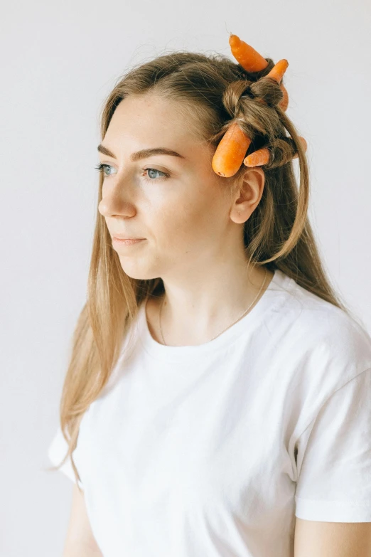  wearing a white t - shirt and flower clip