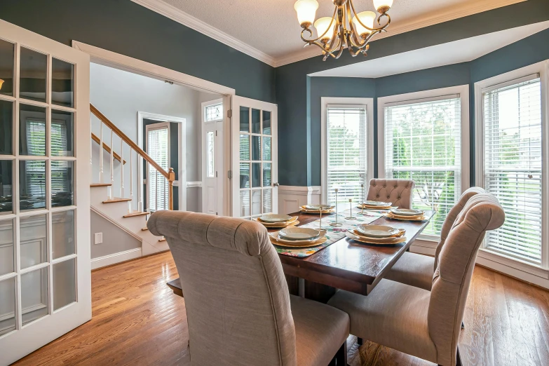 a table with a place setting and windows above it