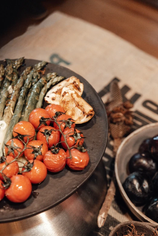 a close up of a plate of food on a table, black and terracotta, vegetables, grill, unbeatable quality