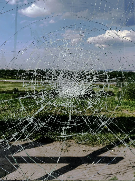 there is a broken glass in front of some grass