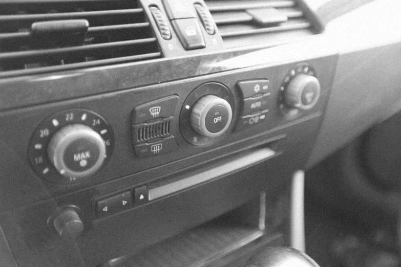 a black and white photo of a car dashboard, an album cover, by Adam Rex, air conditioner, switches, bmw, # e 4 e 6 2 0