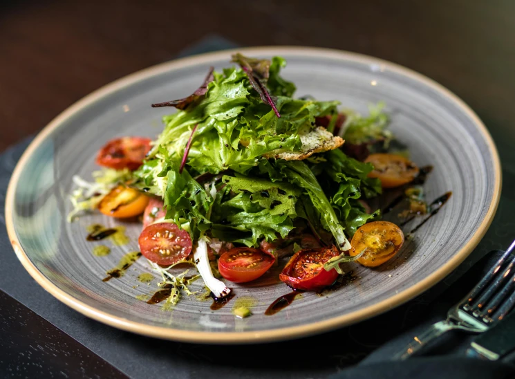 a close up of a plate of food on a table, bacon lettuce and tomatos, fancy dressing, lachlan bailey, herbs