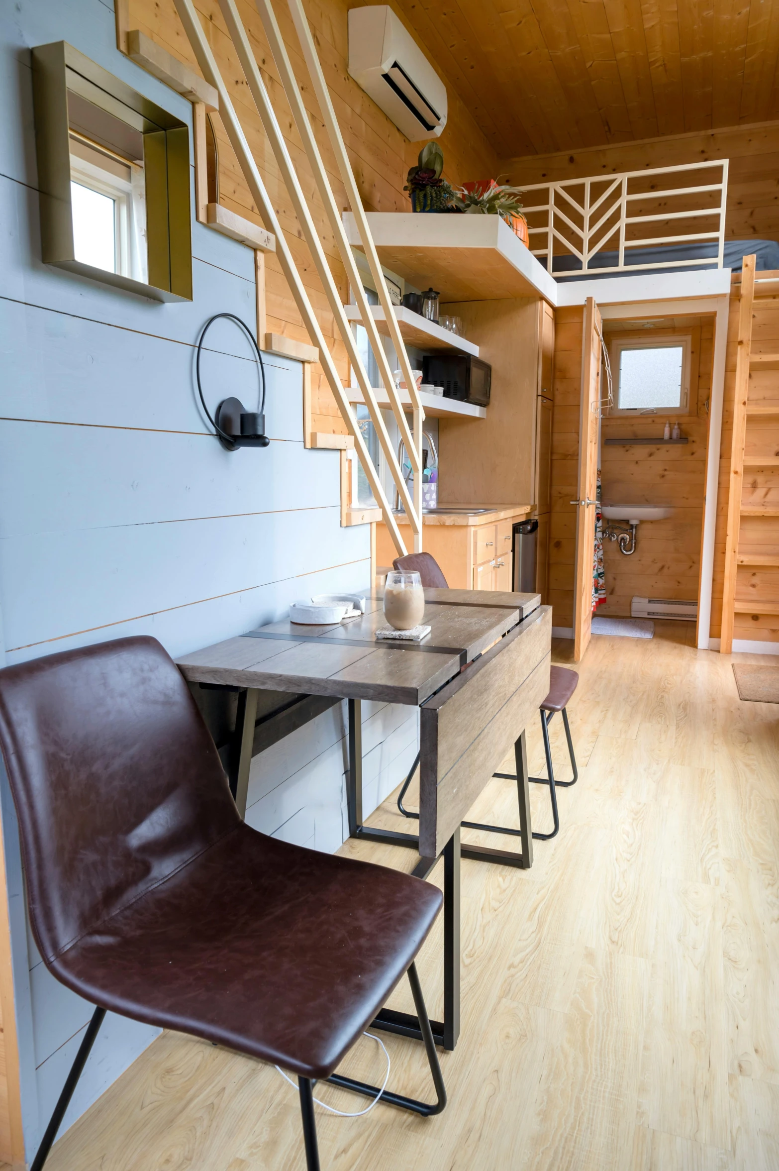 a living area with a wooden ceiling and a table