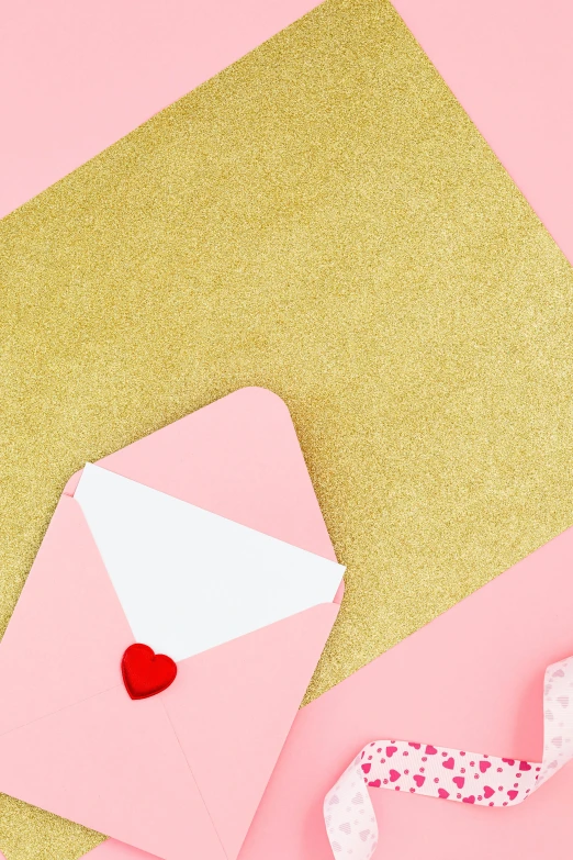 a pink envelope with a red heart on a pink background, by Julia Pishtar, trending on unsplash, glitter sticker, white and gold color scheme, cake, document photo