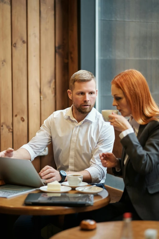 a couple of people sitting at a table with a laptop, hr ginger, aussie baristas, arguing, elegant look