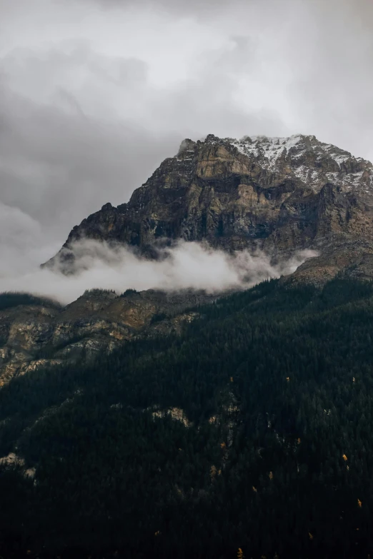 a tall mountain that has some very beautiful clouds in it