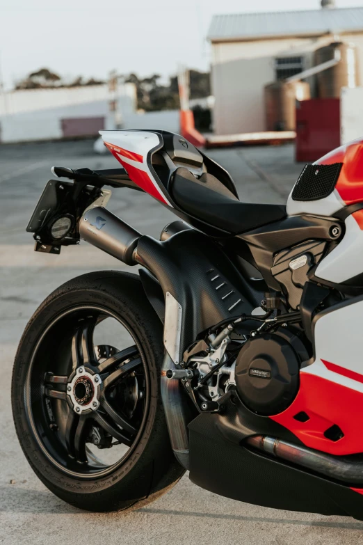 a red and white motorcycle parked in a parking lot, chiron, red and black details, detailed arms, detailed product shot