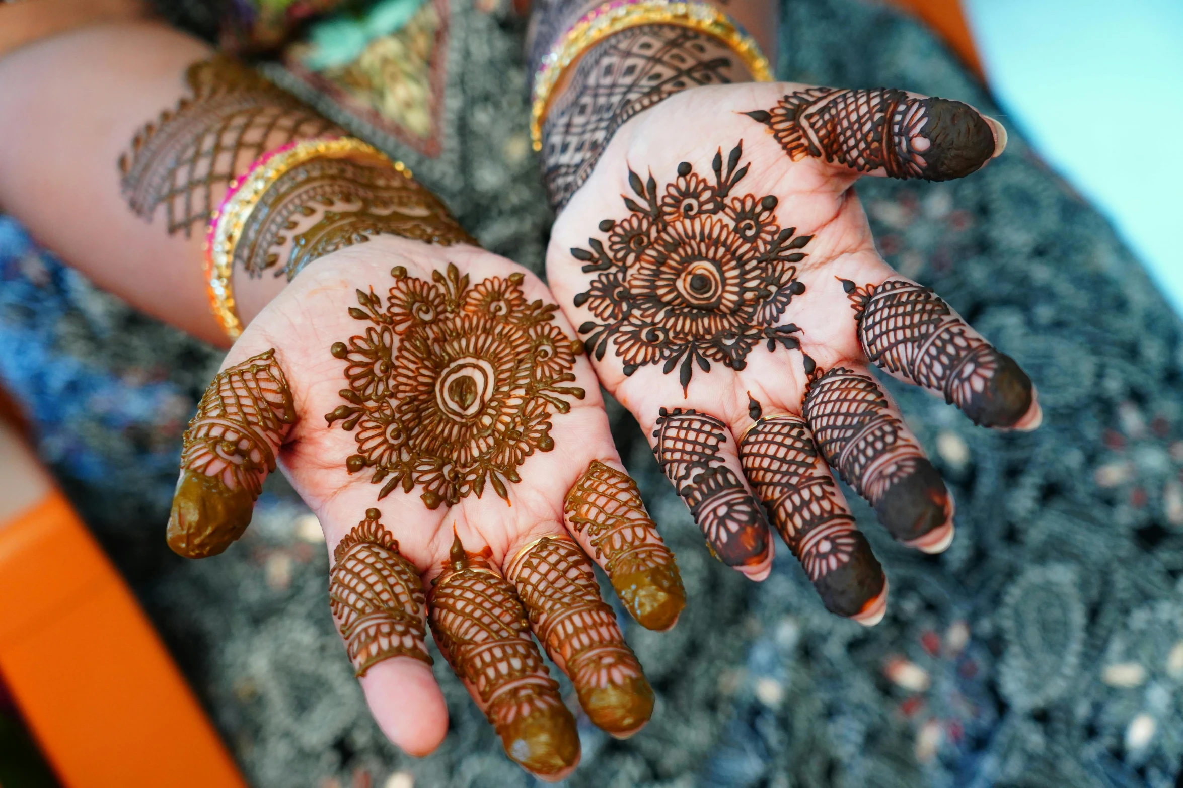 a close up of a person's hands with henna tattoos, an album cover, traditional makeup, palm lines, outside intricate, mandalas