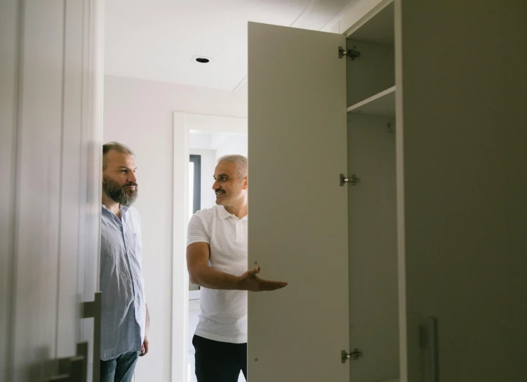 a couple of men standing next to each other in a room, unsplash, happening, cupboards, manly design, maintenance photo, profile image