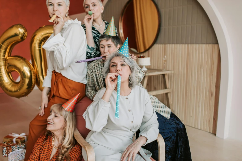 a group of women sitting next to each other, trending on pexels, surrealism, celebrating a birthday, older woman, costume, ad image
