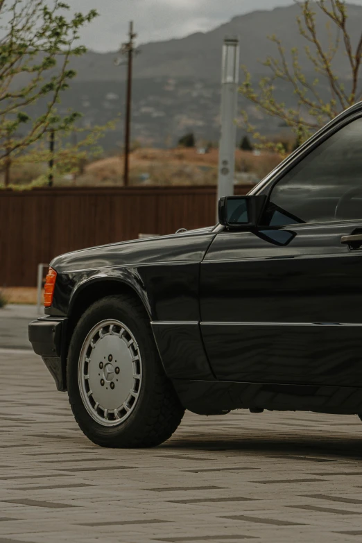 a black car parked on the side of the road, by Sven Erixson, unsplash, photorealism, iroc, close - up profile, from the 8 0 s, profile image