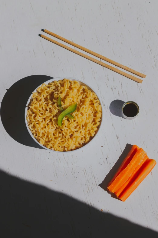 a bowl of noodles, carrots, and chopsticks on a table, inspired by Kanō Hōgai, directional sunlight skewed shot, carson ellis, detailed product image, smooth tiny details