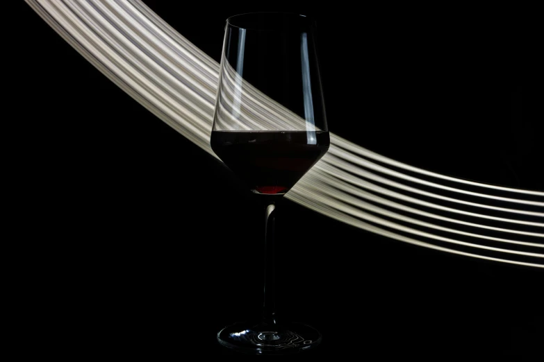 a glass with wine is placed on a table