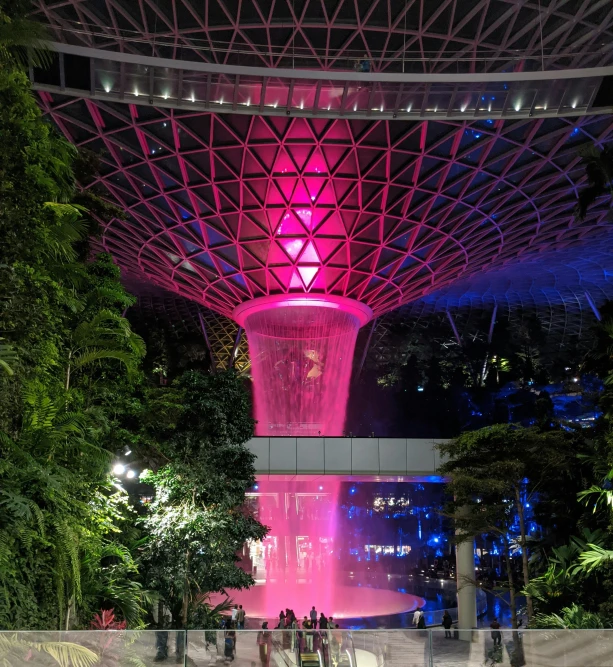 a night time picture of a public park with a fountain