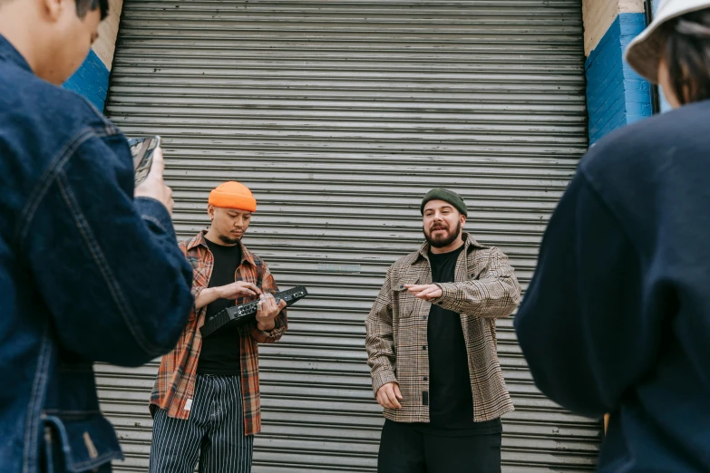 a group of men standing next to each other, unsplash, realism, action bronson, medium shot of two characters, holding it out to the camera, a 35mm photo