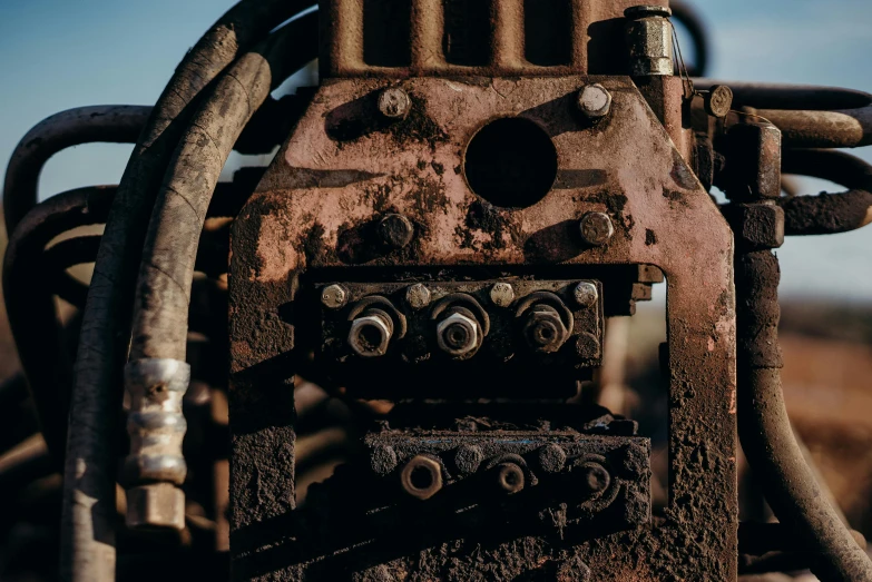 a rusty machine sitting in the middle of a field, an album cover, by Jesper Knudsen, unsplash, close up details, square jaw-line, valves, mining