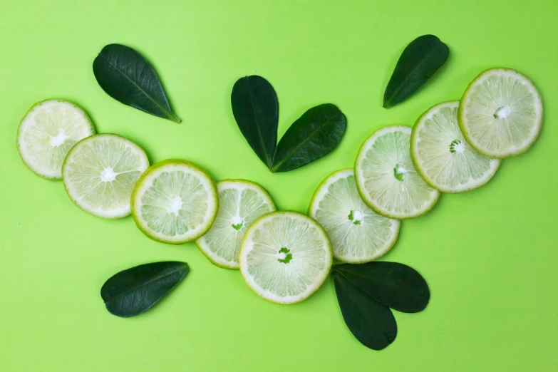 sliced lemons and leaves on a green background, inspired by Grillo Demo, trending on pexels, background image, white neon, moringa juice, thumbnail