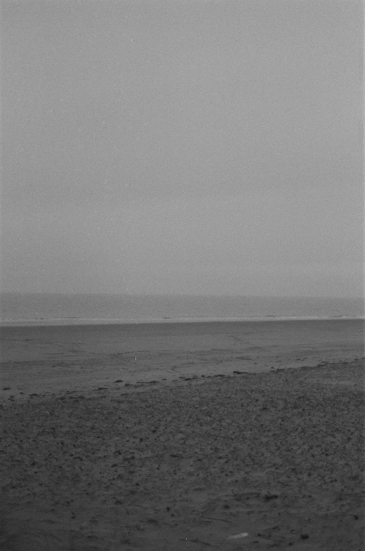 a black and white photo of a beach, tonalism, ground haze, vast expanse, dull, van