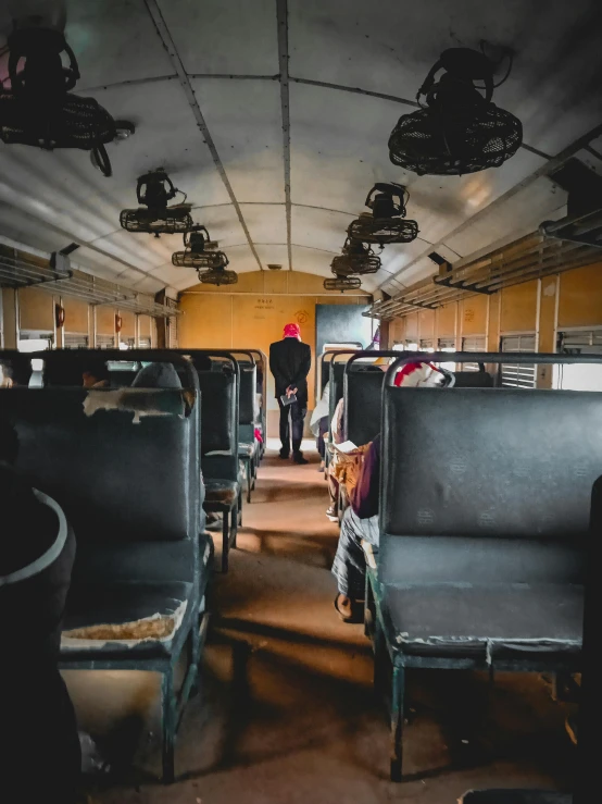 a train car filled with lots of empty seats, a portrait, inspired by Steve McCurry, pexels contest winner, inspect in inventory image, long shot from back, thumbnail, public bus