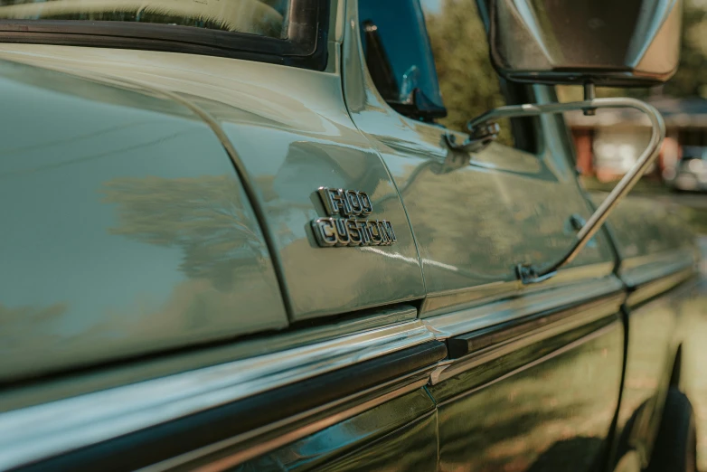 a green car parked on the side of the road, by Tom Bonson, unsplash, photorealism, 1 9 7 0 s car window closeup, profile image, van, detailed and intricate image