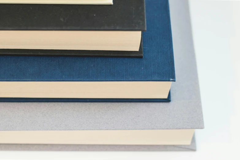 a stack of books sitting on top of each other, an album cover, pexels, academic art, blue and grey, hoog detail, navy, no - text no - logo