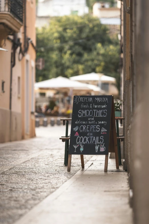 a sign that is on the side of a building, pexels contest winner, in a sidewalk cafe, mediterranean, blackboard, shady alleys