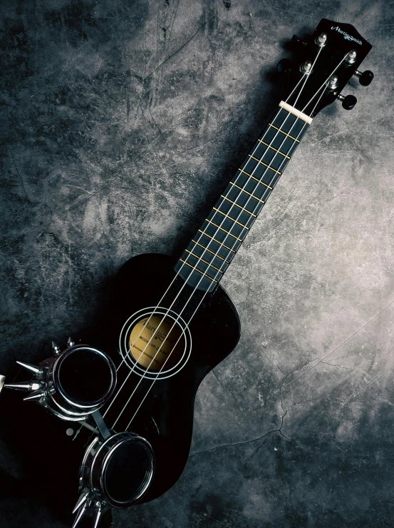 a black guitar sitting on top of a table, ukulele, trending on spotify, profile picture, charcoal and silver color scheme