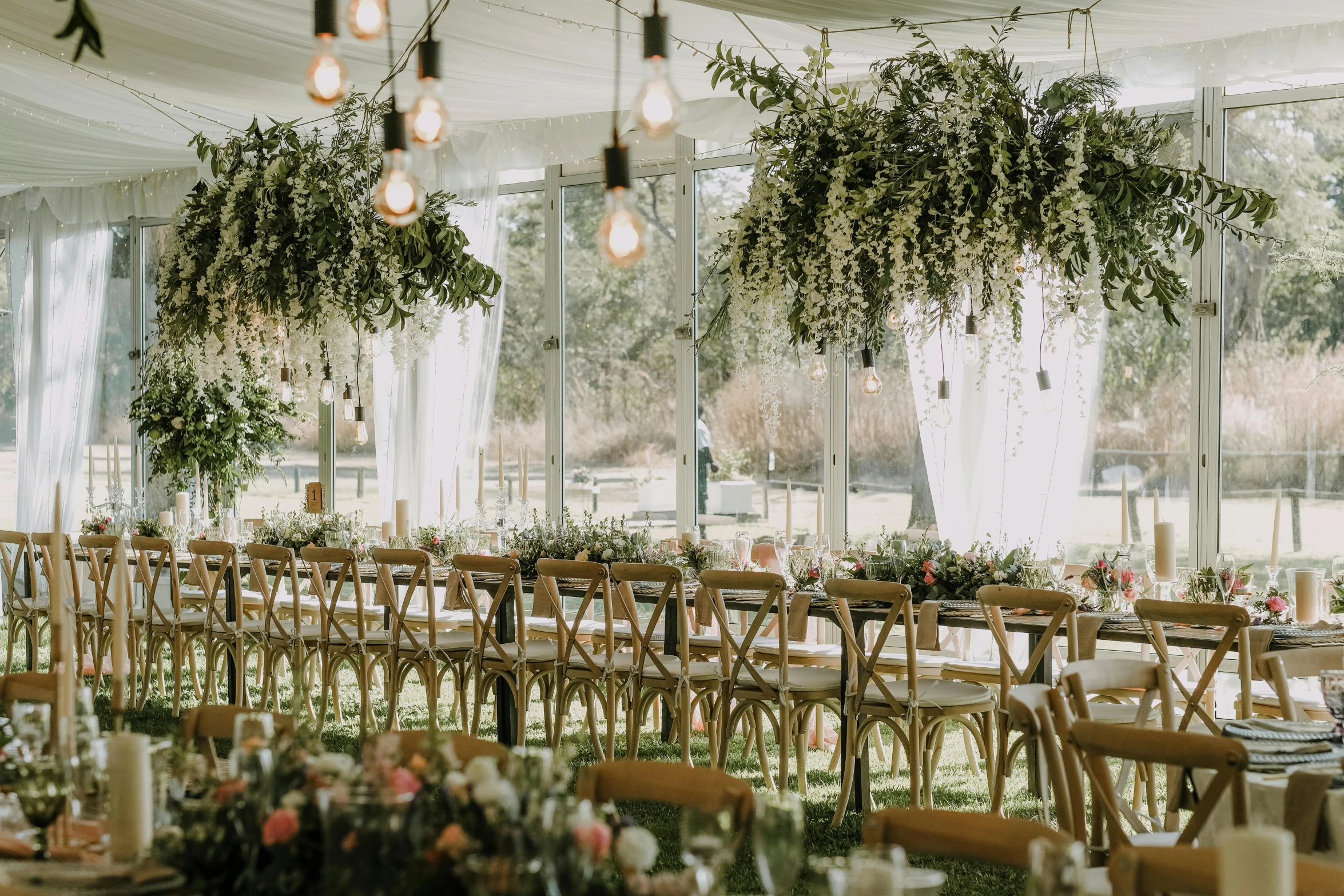 an event with clear walls, tables, and chairs set up for the guests