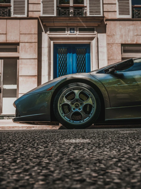 the side view of a vehicle parked in front of a building