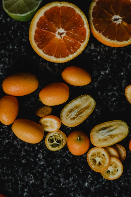 a bunch of oranges sitting on top of a table, by Carey Morris, pexels contest winner, process art, abundant fruition seeds, smooth marble surfaces, dark hues, thumbnail