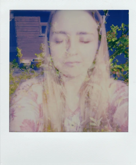 a close up of a person with long hair, a polaroid photo, inspired by Elsa Bleda, happening, blue and green and red tones, in the garden, solarised, purple filter