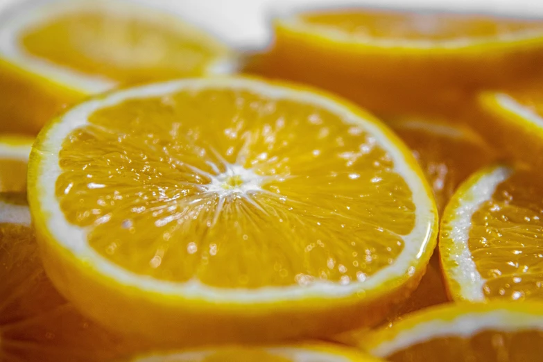 a pile of sliced oranges sitting on top of each other, a macro photograph, by Carey Morris, pexels, with a bright yellow aureola, 🦩🪐🐞👩🏻🦳, lemonade, closeup photo