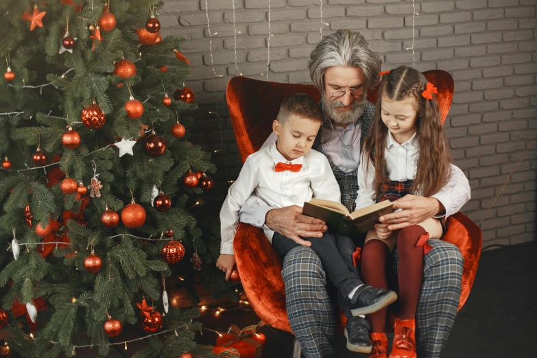 a man reading a story to two little girls