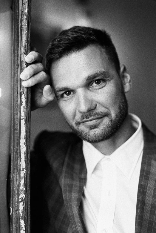 a black and white photo of a man in a suit, a black and white photo, shutterstock, photorealism, liam, gallant, promotional image, artem