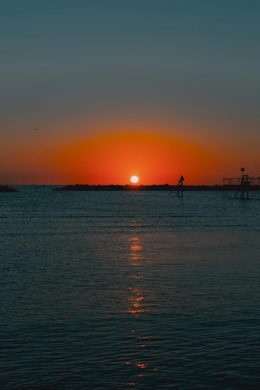 the sun is setting over a body of water, a picture, by Robbie Trevino, mediterranean, -n 9, red sea, large twin sunset