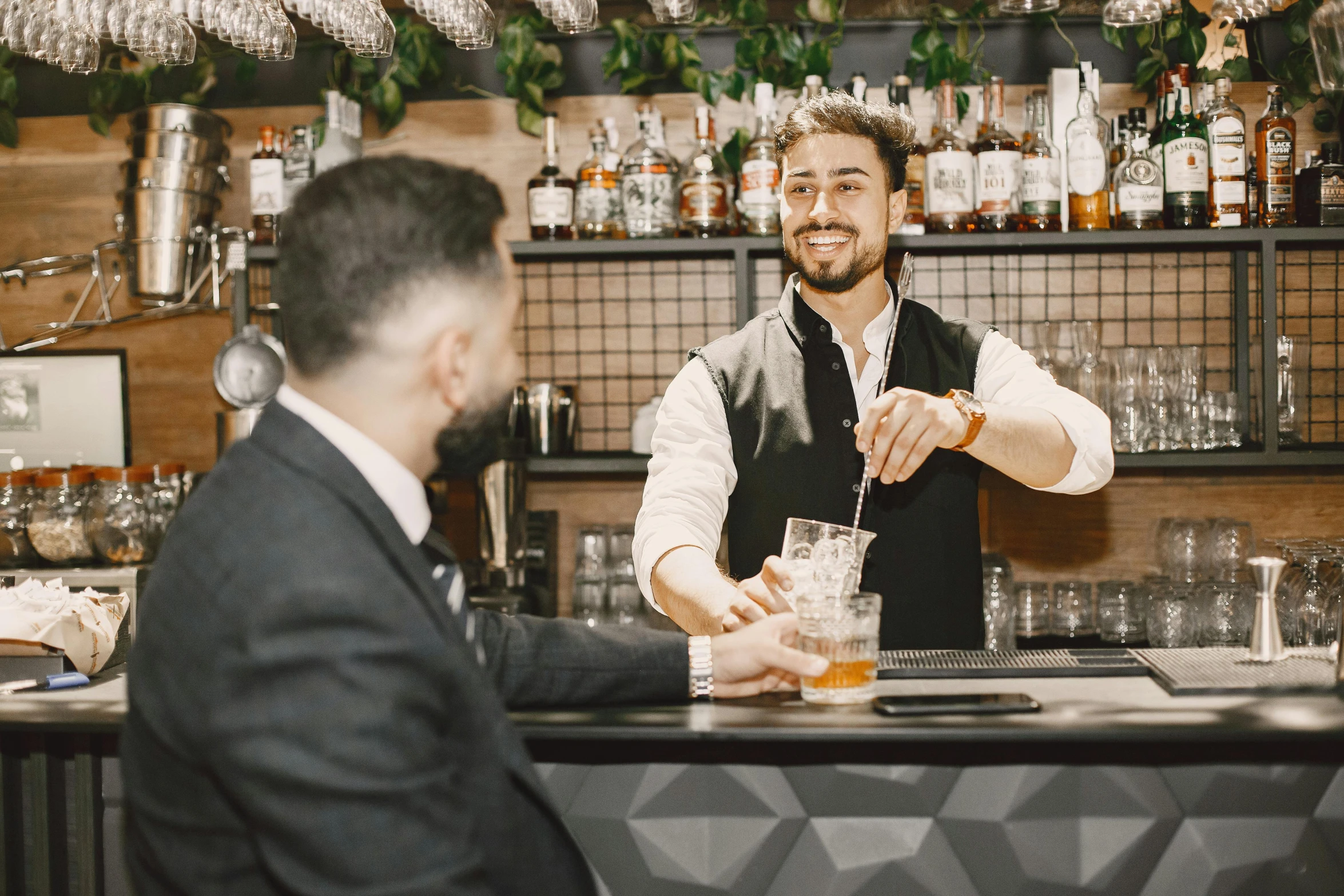 a man sitting at a bar pouring a drink, pexels contest winner, server in the middle, guido reni style, lachlan bailey, profile image