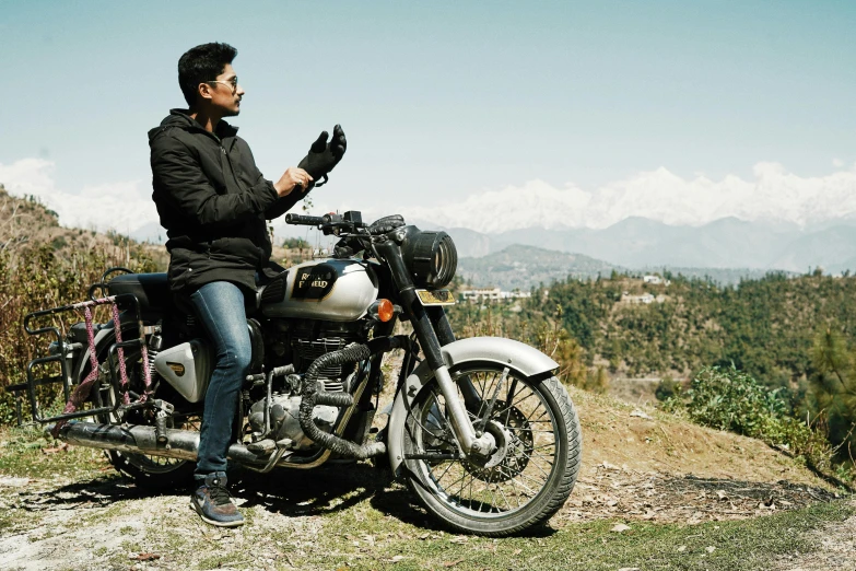 a man that is sitting on a motorcycle, pexels contest winner, himalayas, profile pose, hand, without helmet