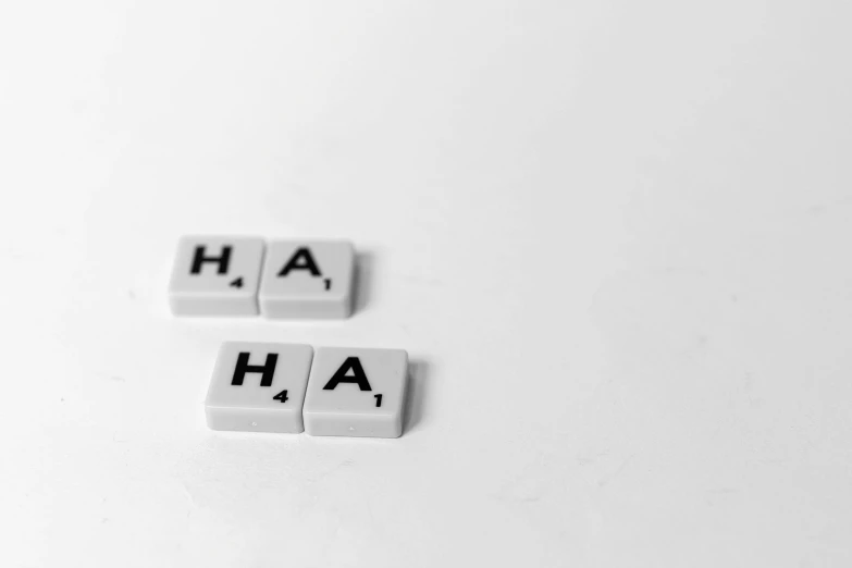 white word shaped tile type block with the word ha and two smaller cubes