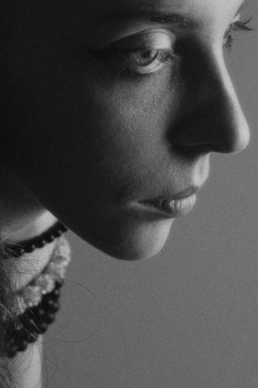 a black and white photo of a woman's face, inspired by Max Dupain, hyperrealism, close - up profile, androgyny, **cinematic, still from a music video