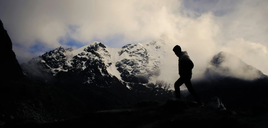 a person standing on the side of a mountain