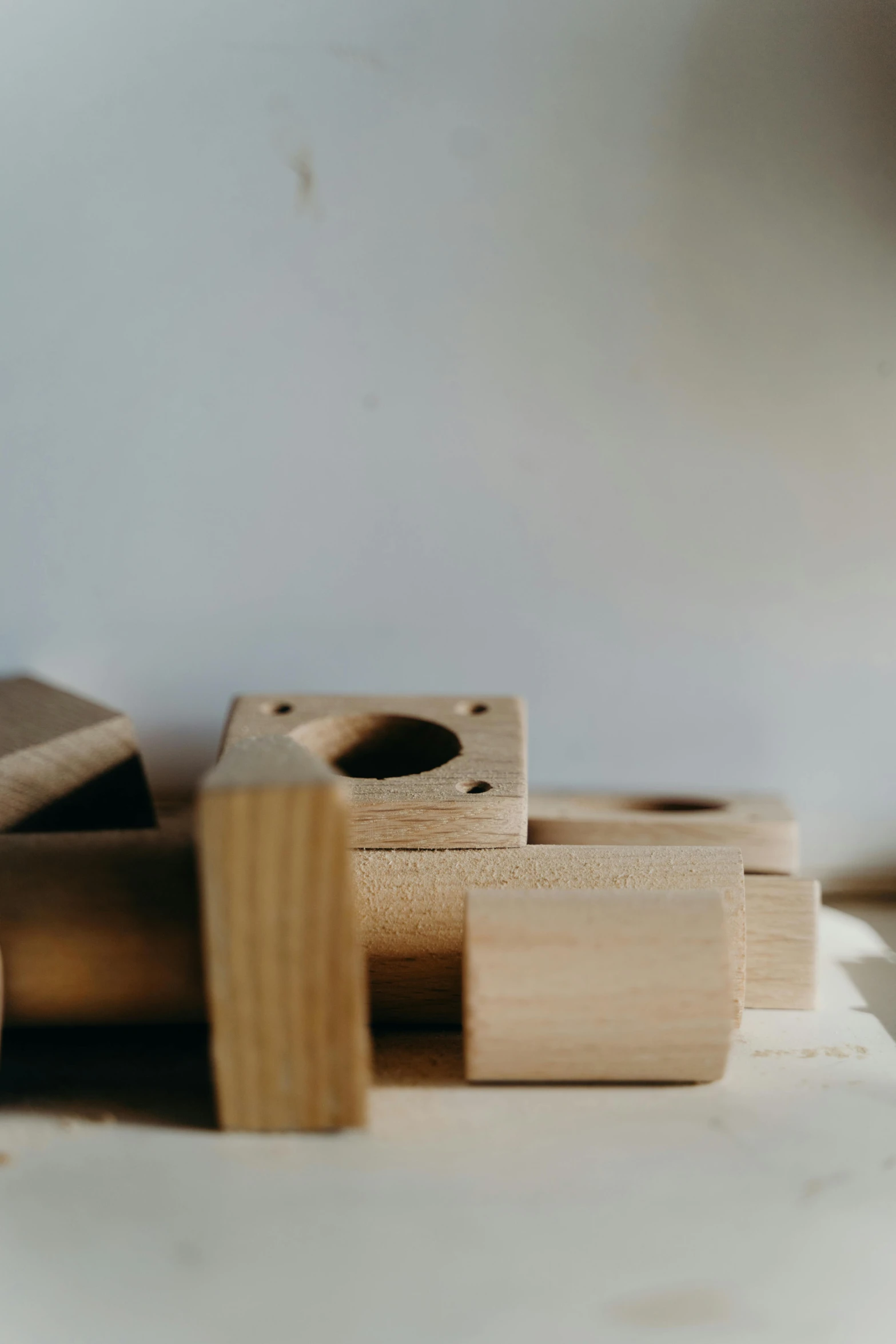 a pile of wooden blocks sitting on top of a table, inspired by Isamu Noguchi, unsplash, holes, wheels, box, toy photo