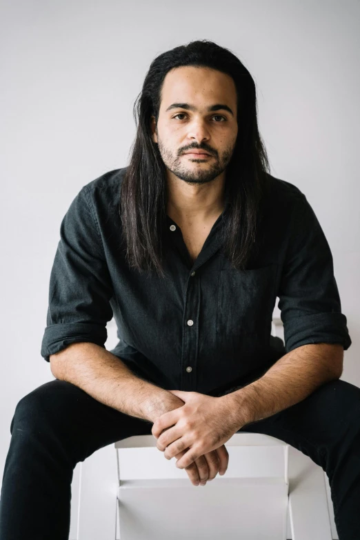 a man sitting on top of a chair looking at the camera