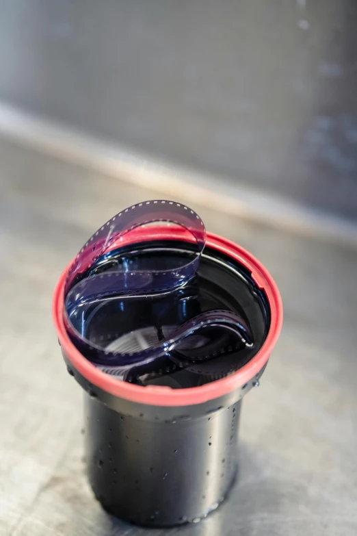 an empty black container sitting on a counter