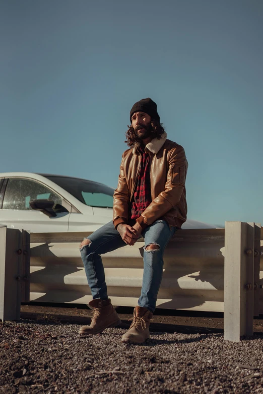 a man sits on a bench and looks off into the distance