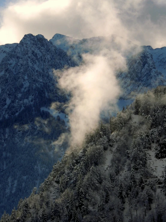 clouds and fog fill the air over mountains